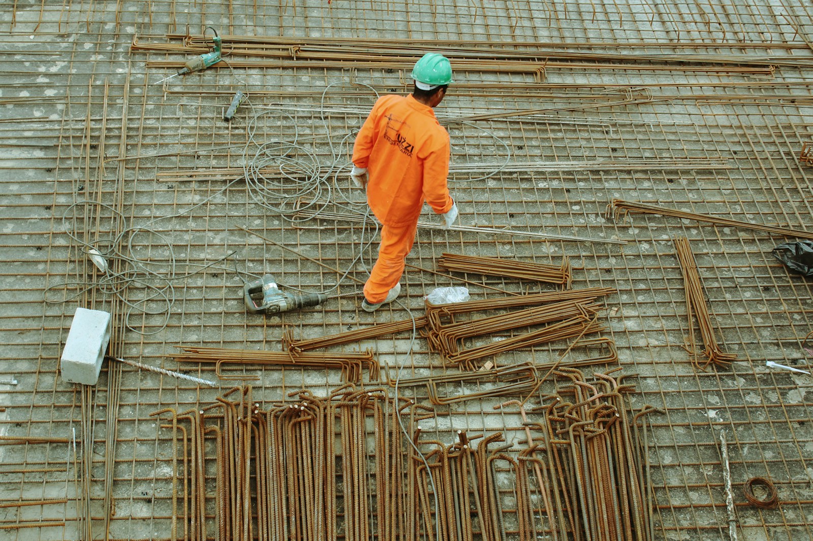 Photo by Guilherme Cunha man walking on construction site